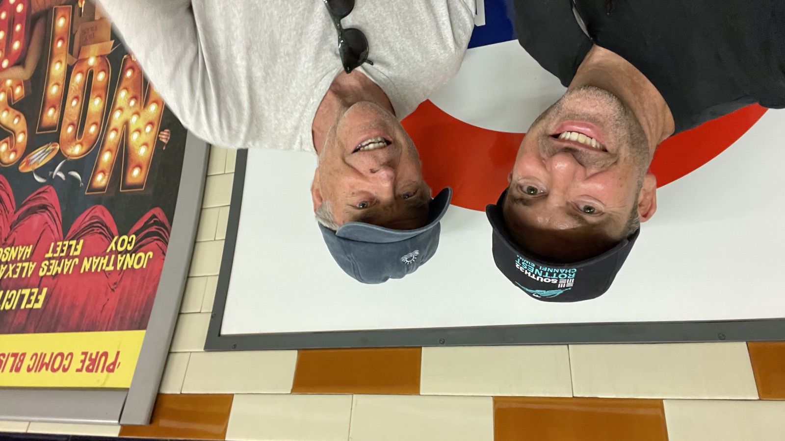 Marc Schregardus, in a Rottnest Channel Swim cap, and Garry Luscombe together on the London Underground